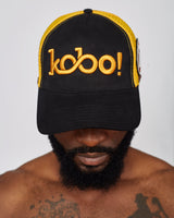 KOBO Suede Trucker Hat: Midnight Black & Palm Gold